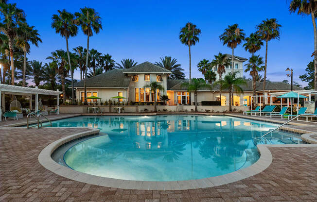 A large house with a pool in front of it.