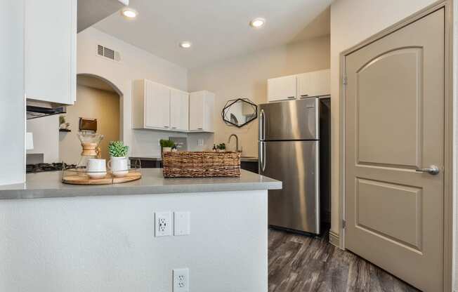 a kitchen with a counter top and a stainless steel refrigerator at Mirasol Apartments, Las Vegas, NV