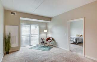 A room with a chair and a table in it.