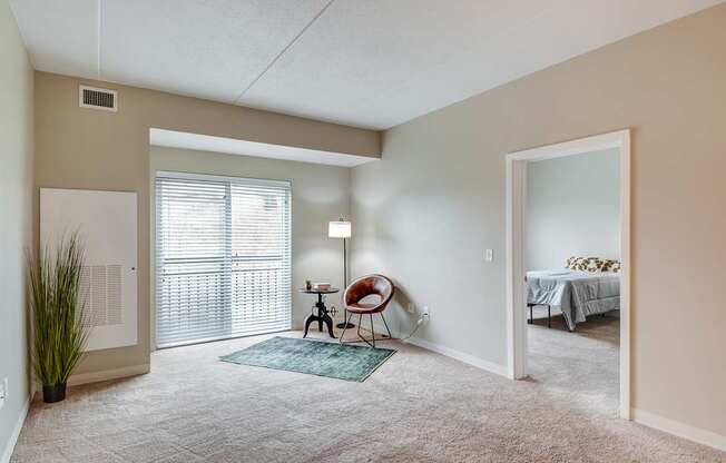 A room with a chair and a table in it.