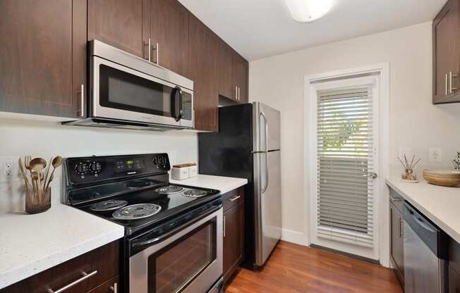 a kitchen with a stove microwave and refrigerator