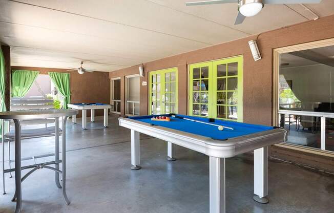 a game room with a pool table and a bar