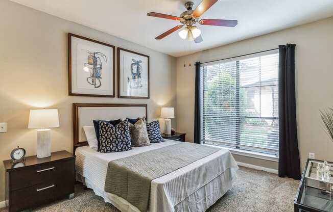 the preserve at ballantyne commons bedroom with ceiling fan and large window