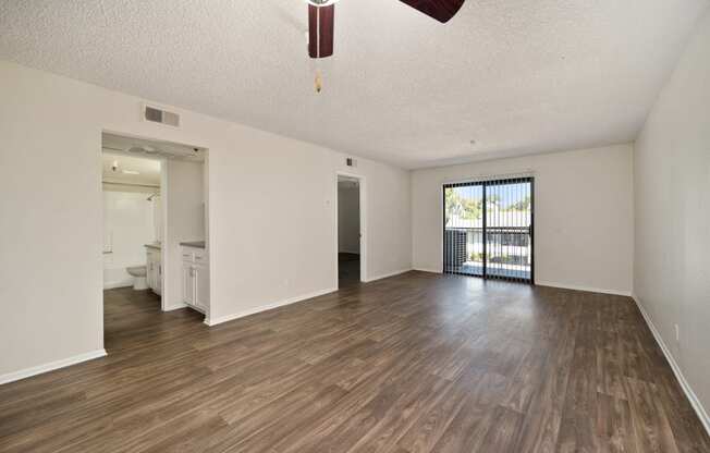 a 2-bedroom apartment living and room with wood floors and a ceiling fan