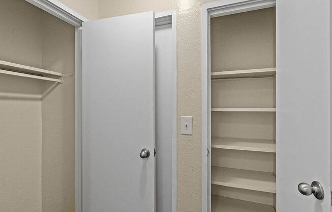 a bathroom with a closet and an open door