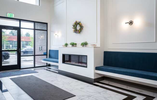 a living room with a fireplace and blue couches