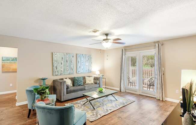 a living room with a couch and a ceiling fan at Avalon Apartment Homes, Starkville, MS, 39759