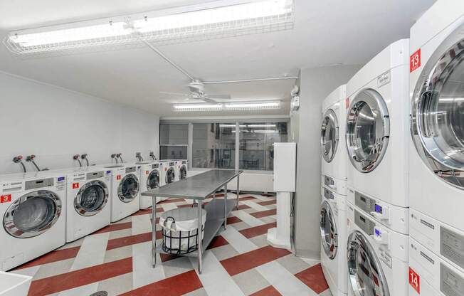 a washer and dryer room with washing machines and a table