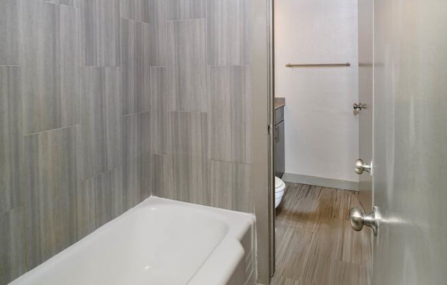 Oval Tub with Subway Tile at Memorial Towers Apartments, The Barvin Group, Houston, TX, 77007