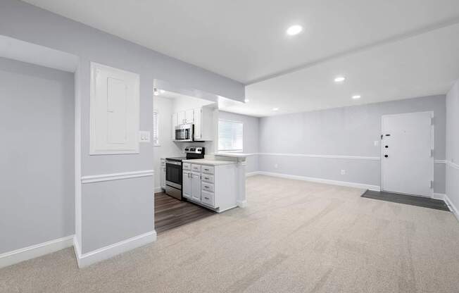 A kitchen with white appliances and cabinets is shown.