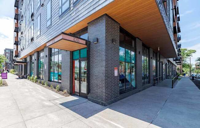 A modern building with a wooden overhang and glass windows.