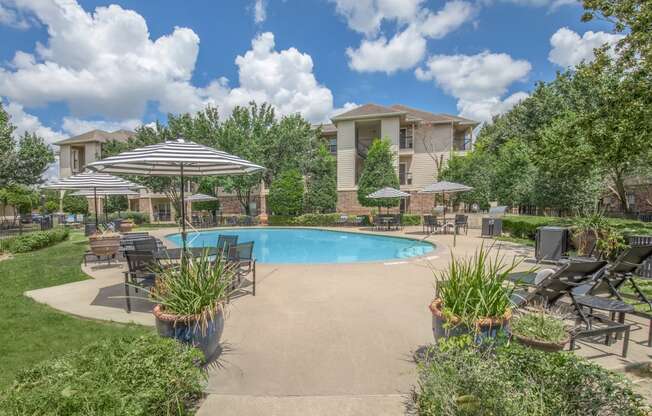 Affordable Houston Texas Apartments – Westchase Forest – Photo of a swimming pool with patio furniture and umbrellas