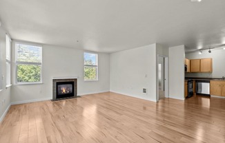 a living room with a fireplace and wooden floors