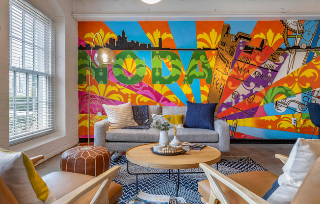 a living room with a colorful mural on the wall at Highland Mill Lofts, North Carolina, 28205