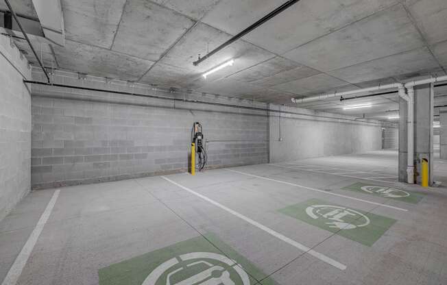 A parking garage with a bicycle parked in the corner.