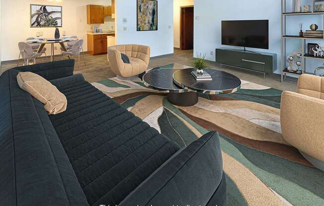 A living room with a black sofa and a coffee table.