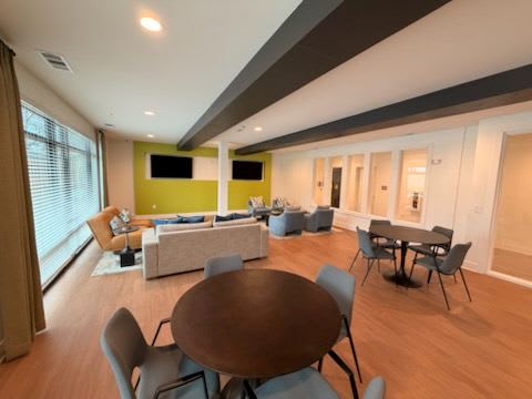 A modern living room with a brown table and chairs.