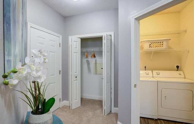 a laundry room with a washer and dryer and a closet