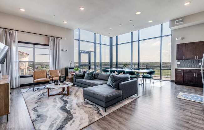 A modern living room with a large grey sofa and a coffee table.