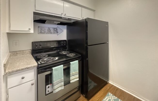 a kitchen with stainless steel appliances and a refrigerator