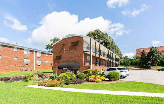 a large brick building with a parking lot in front of it