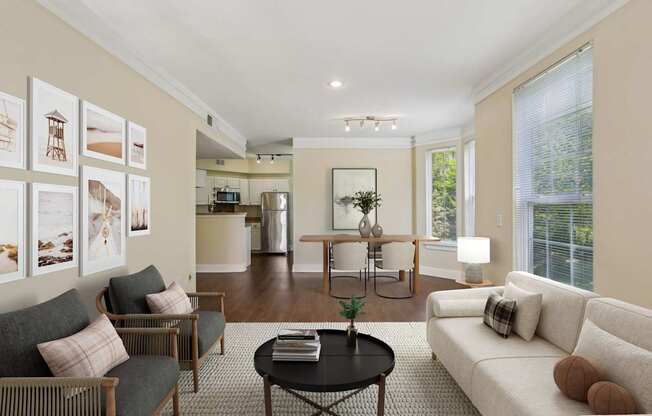 A living room with a grey couch, a black coffee table, and a white sofa.