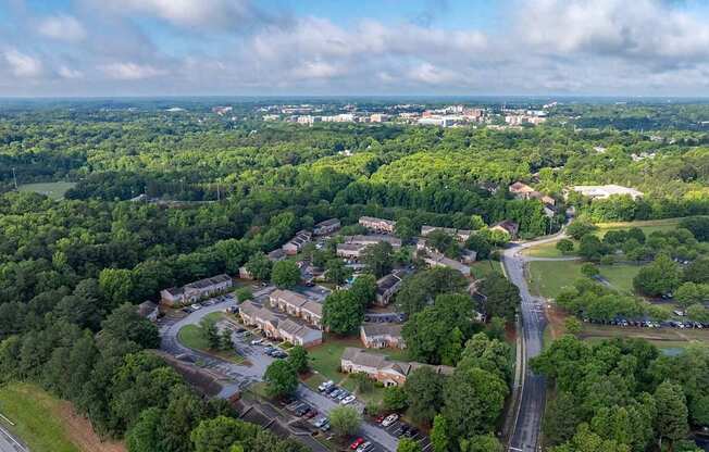 A bird's eye view of a small town with a mix of greenery and buildings.