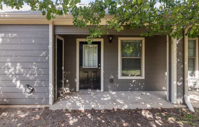 the front of a house with a porch and a door