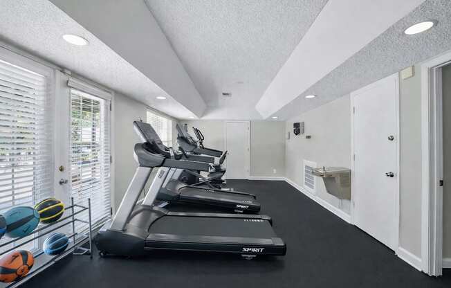 A treadmill is on the left side of the room.