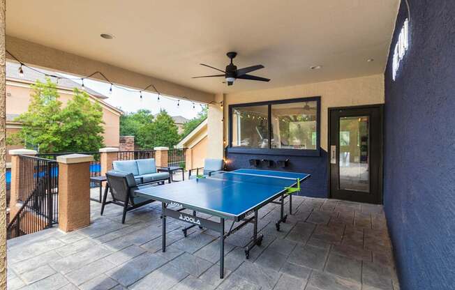A blue table with a JOOO table tennis paddle on it.