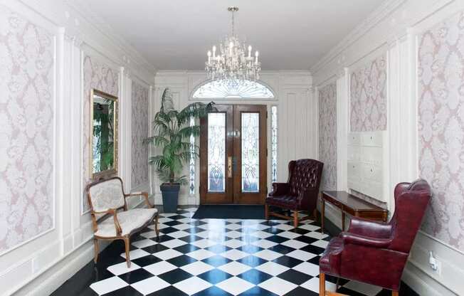 a living room with a checkered floor and a chandelier