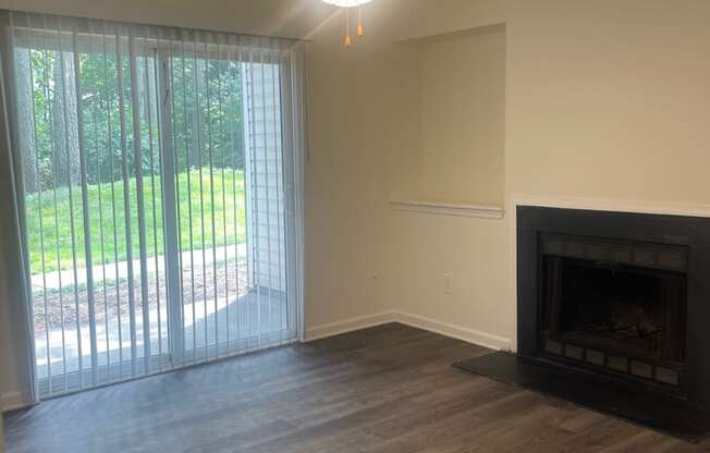 a living room with a fireplace and a ceiling fan