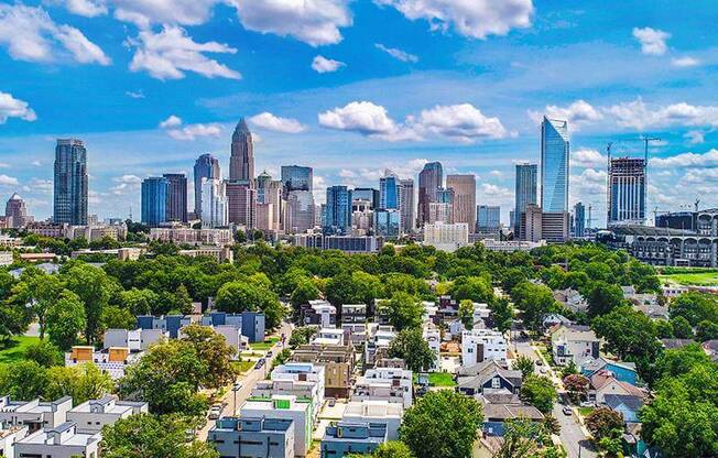 a view of a city skyline with trees and buildings