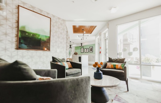 a living room with couches and chairs and a table