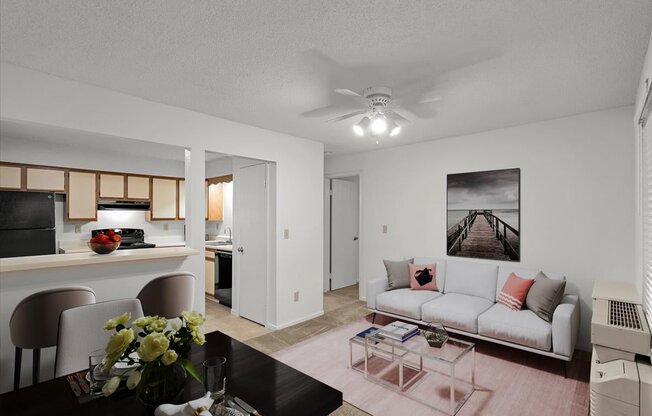 a living room and kitchen with a couch and a tableat Millcreek Woods Apartments, Olathe, KS, 66061