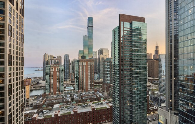 A cityscape with a mix of modern and older buildings, with a clear sky above.