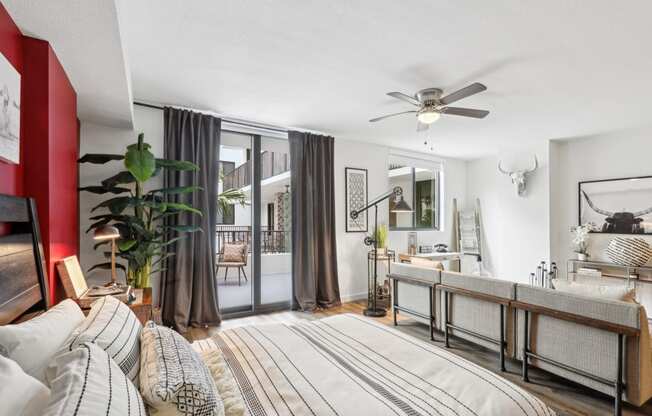 a bedroom with a bed and a ceiling fan