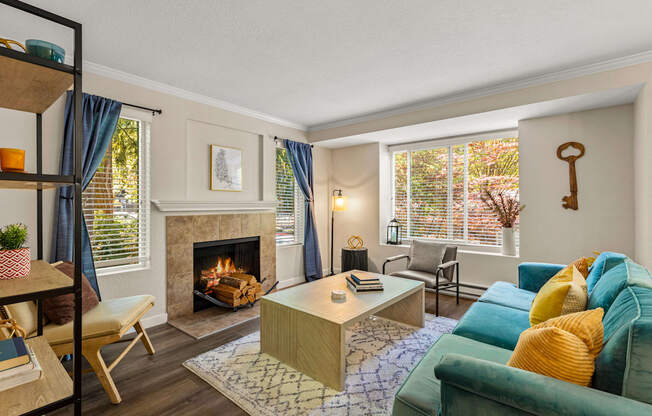 A living room with a fireplace and a green couch.