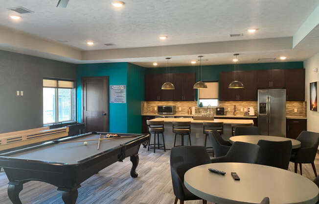 a game room with a pool table and a bar
