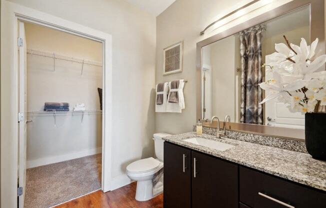 a bathroom with a shower toilet and sink and a mirror at Link Apartments® Brookstown, North Carolina