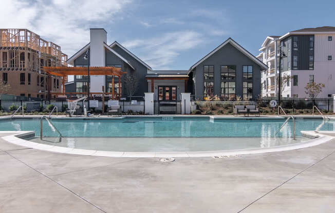a swimming pool with a building in the background