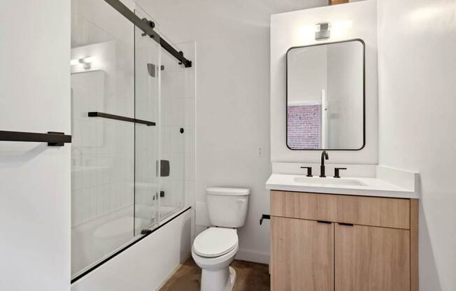 A white toilet sits next to a sink in a modern bathroom.