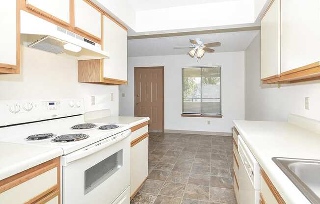 Galley Kitchen with White Appliances and Tile Style Flooring