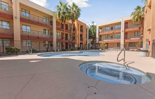 Relax by the pool in this serene apartment courtyard, offering a perfect blend of leisure and style.