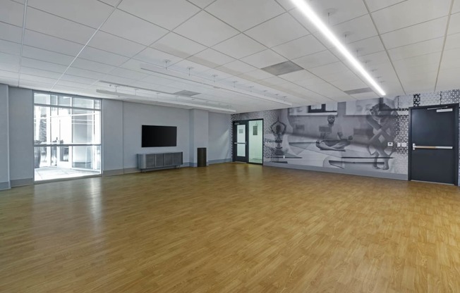 a large room with wood floors and a mural on the wall  at Vue, California, 90731