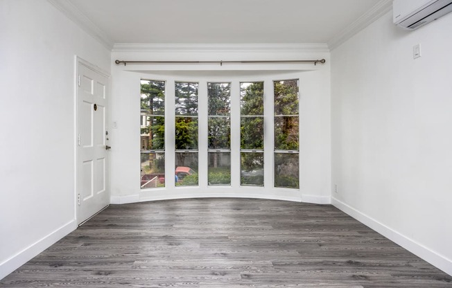 an empty room with a bay window