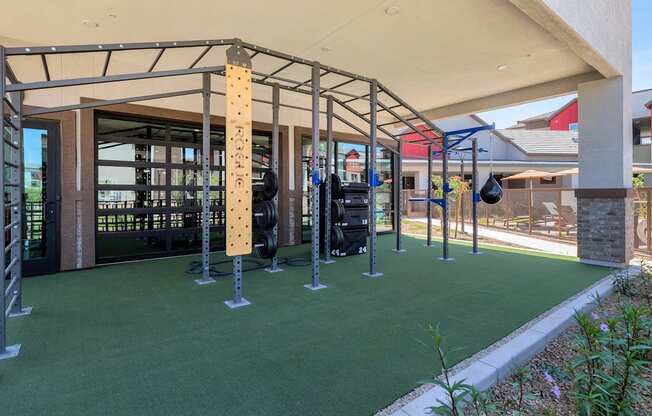 a fitness center with weights and other equipment in a buildingat Weylyn Luxury Apartments, Arizona, 85339