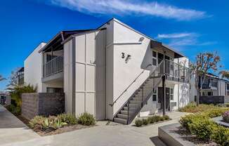 a building with stairs and a blue sky in the background