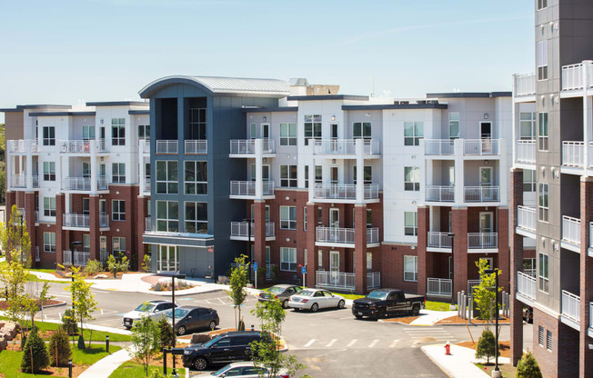 an aerial view of an apartment complex with cars parked in a parking lot