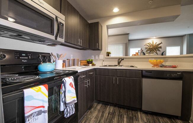 a kitchen with a stove microwave and sink
